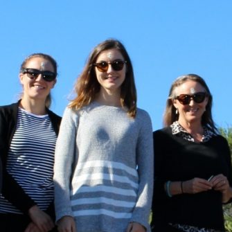 KLC members standing on grass with sky behind