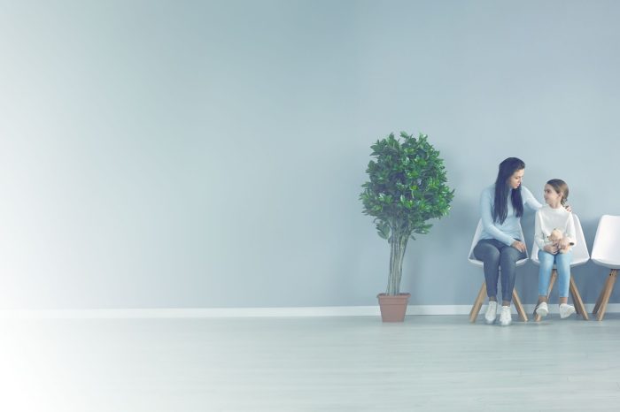 Photo of mother and daughter waiting in doctors office