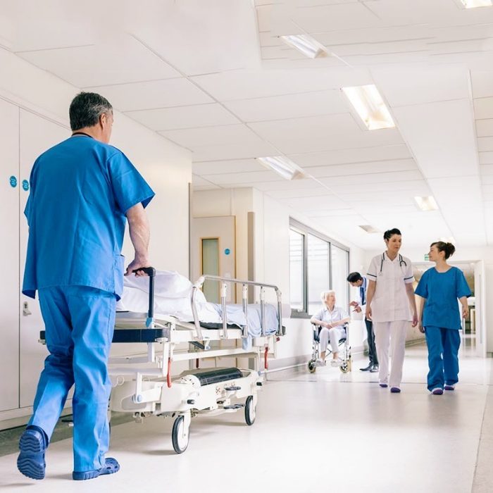 Doctors Hospital Corridor Nurse Pushing Gurney Stretcher Bed