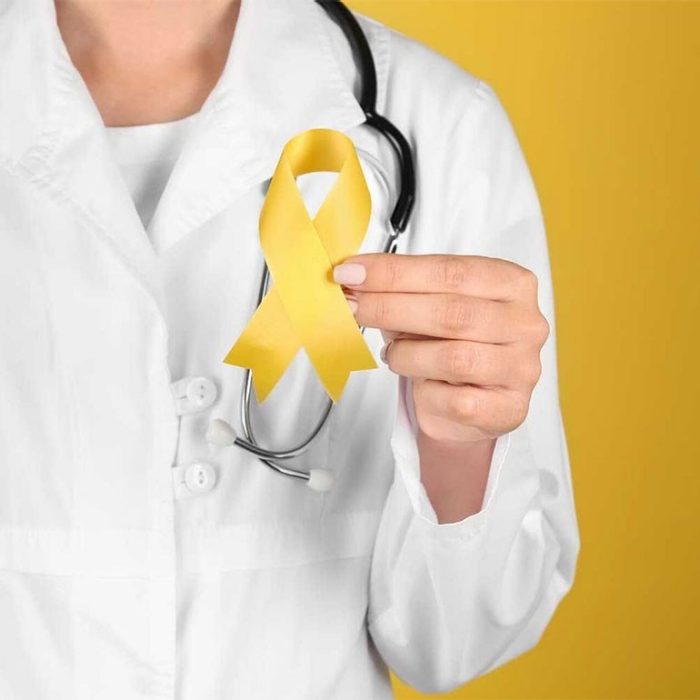 Doctor holding yellow ribbon