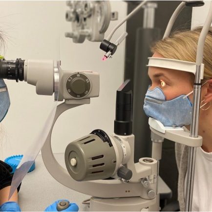 Optometry student examining a patient