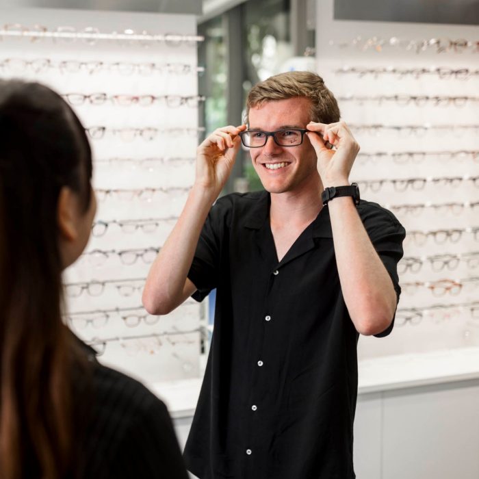 trying on glasses in optometry class