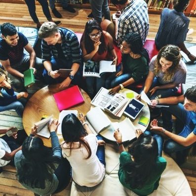 group of students talkin in the library