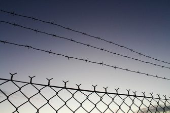 Fence with barbed wire