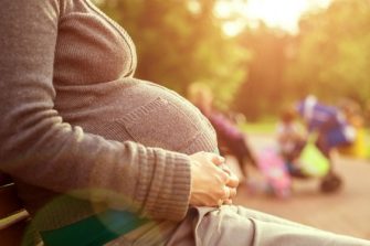 Pregnant woman sitting on bench