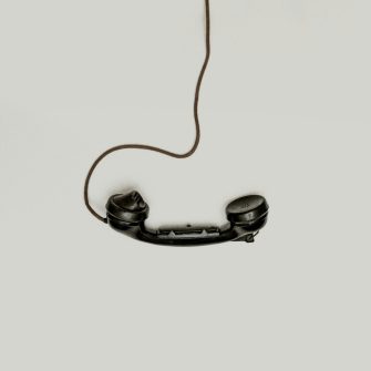 Old fashioned telephone with a chord