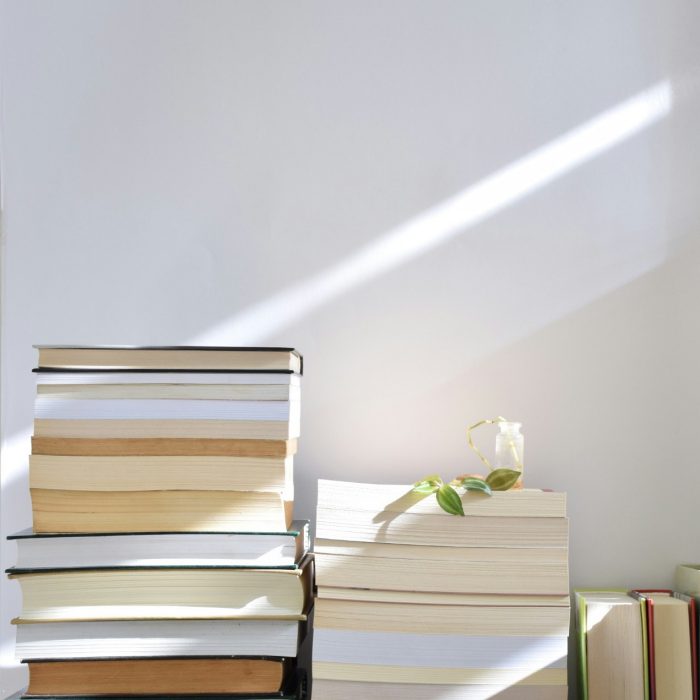 Books stacked against a wall