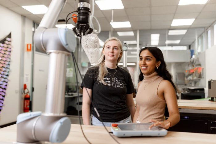 ADA Technician and student working with a collaborative robot.