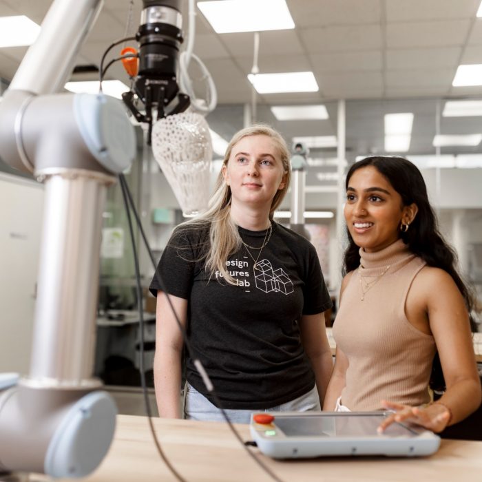 ADA Technician and student working with a collaborative robot.