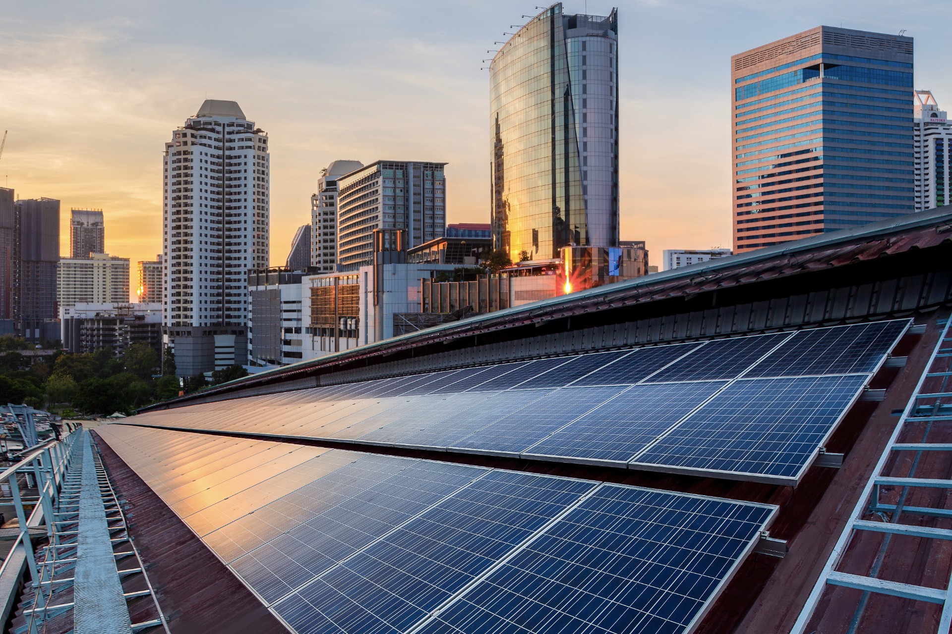 Solar Panel Photovoltaic installation on a Roof of factory, sunny blue sky background, alternative electricity source - Sustainable Resources Concept.