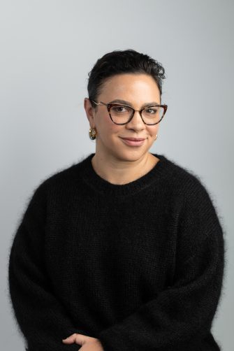 portrait picture of Peta wearing a black knitwear