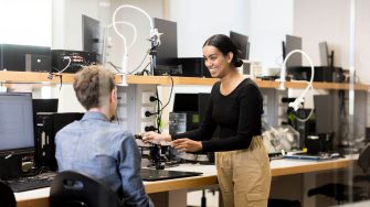 Students work with a lecturer to understand sophisticated practical telecommunications equipment