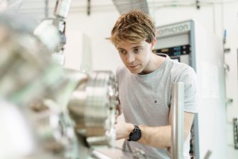 Male student working with equipment in a science laboratory