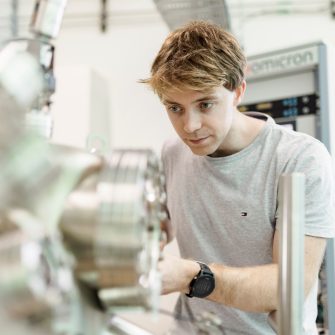 Male student working with equipment in a science laboratory