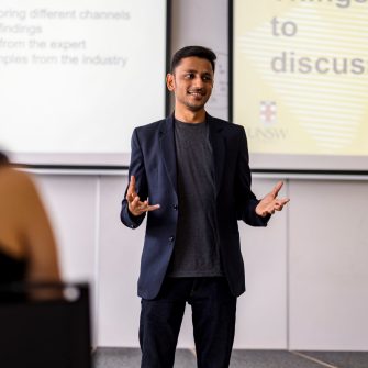 Business school student presenting in front of a classroom