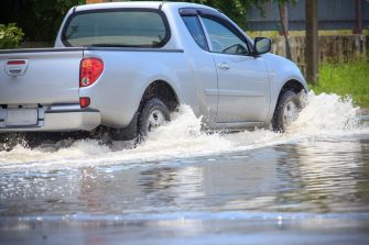 Splash by a car as it goes through flood water