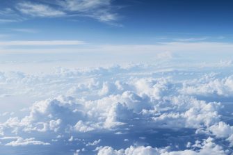 A photo of the sky taken from an airplane, showing white clouds and blue skies. The perspective is from above looking down at vast cloud formations stretching to infinity, 8k resolution, Nikon --ar 7:3 --style raw --stylize 0 Job ID: 052cface-820b-4e8a-956b-d725ea667647 AdobeStock_836439082