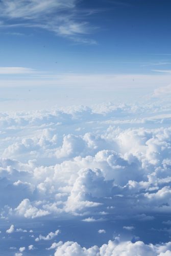 A photo of the sky taken from an airplane, showing white clouds and blue skies. The perspective is from above looking down at vast cloud formations stretching to infinity, 8k resolution, Nikon --ar 7:3 --style raw --stylize 0 Job ID: 052cface-820b-4e8a-956b-d725ea667647 AdobeStock_836439082