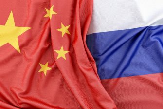 Fabric flag of China is touching flag of Russia. 3D Rendering