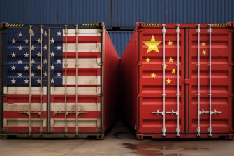 Two shipping containers side by side. One painted with the American flag, the other painted with the Chinese flag