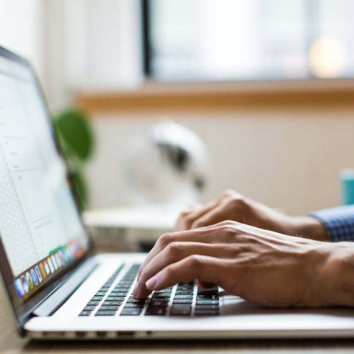 Person typing on a laptop