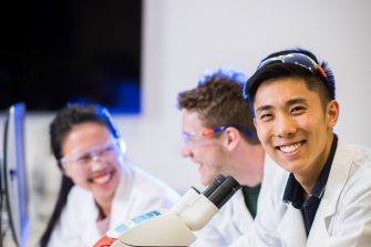 Photograph of students using microscope