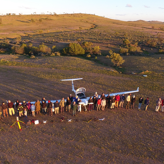 group photo of staff around plane