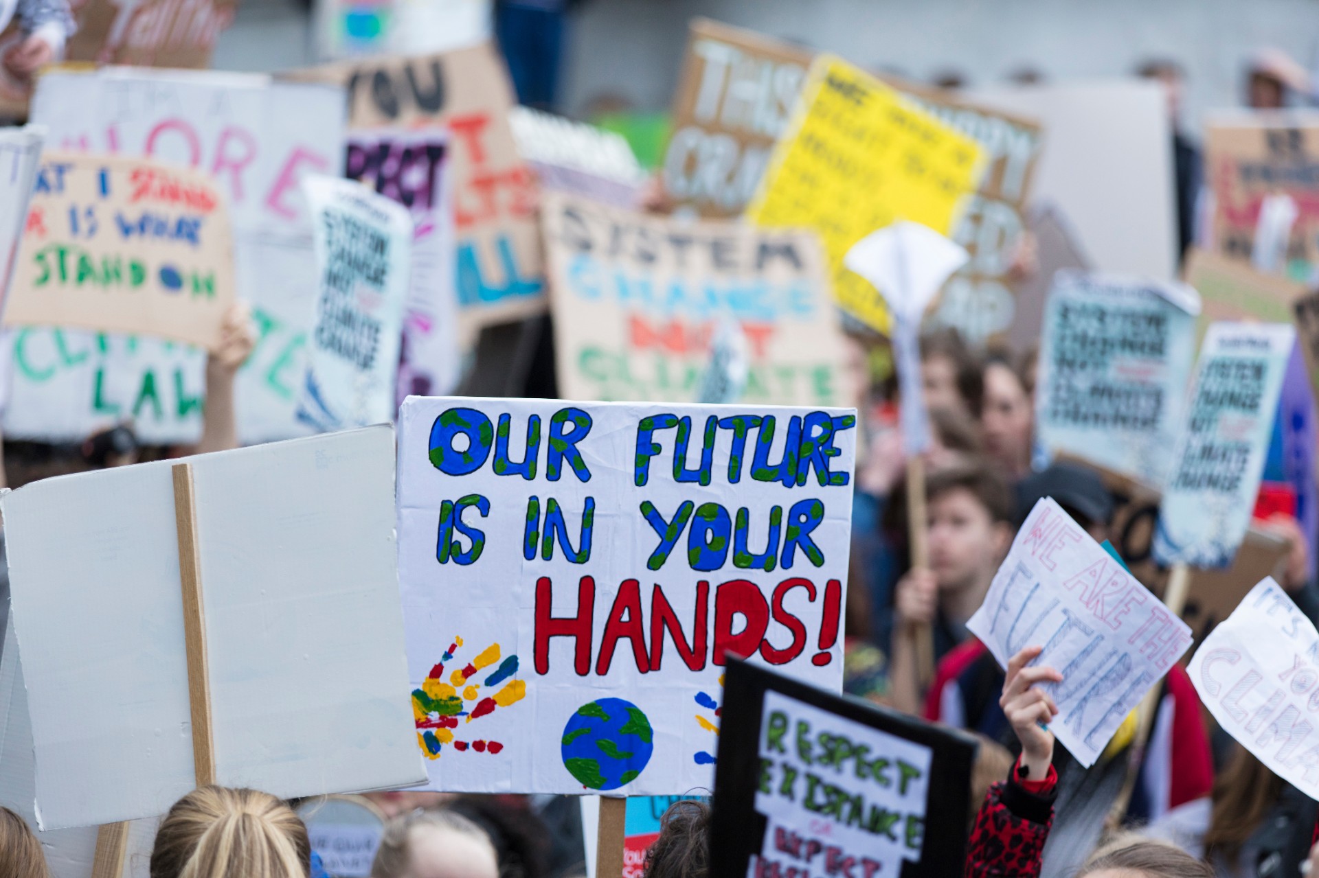 People with banners protest as part of a climate change march