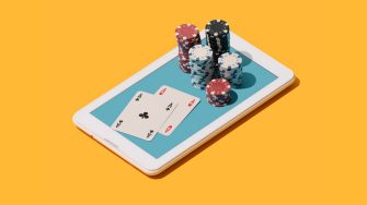 Online Texas hold 'em poker game app: stacked chips and cards on a touch screen smartphone