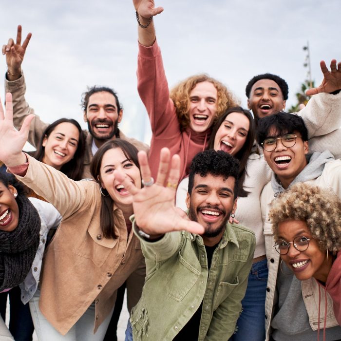 Big group of cheerful young friends taking selfie portrait. Happy people looking at the camera smiling. Concept of community, youth lifestyle and friendship. High quality photo