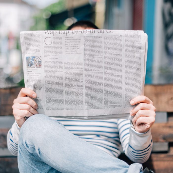 Person reading newspaper