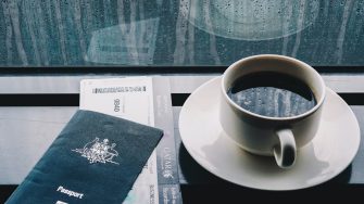 Australian passport, boarding pass and cup of coffee