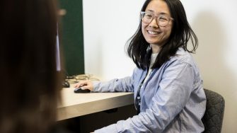 Student Advisor helping student at desk