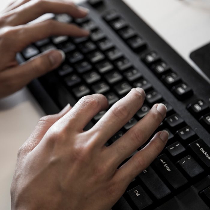 Close up of hands on keyboard