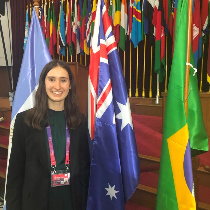 a girl standing to flag of Australia