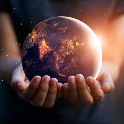 Photo of hands holding globe