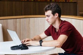 Photo of student using laptop on campus