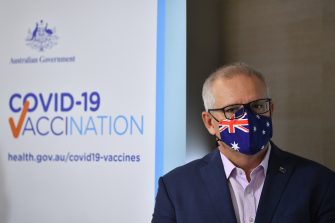 Former Prime Minister Scott Morrison wearing an flag-stylised mask  at a COVID-19 vaccination announcement event