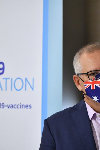 Former Prime Minister Scott Morrison wearing an flag-stylised mask  at a COVID-19 vaccination announcement event