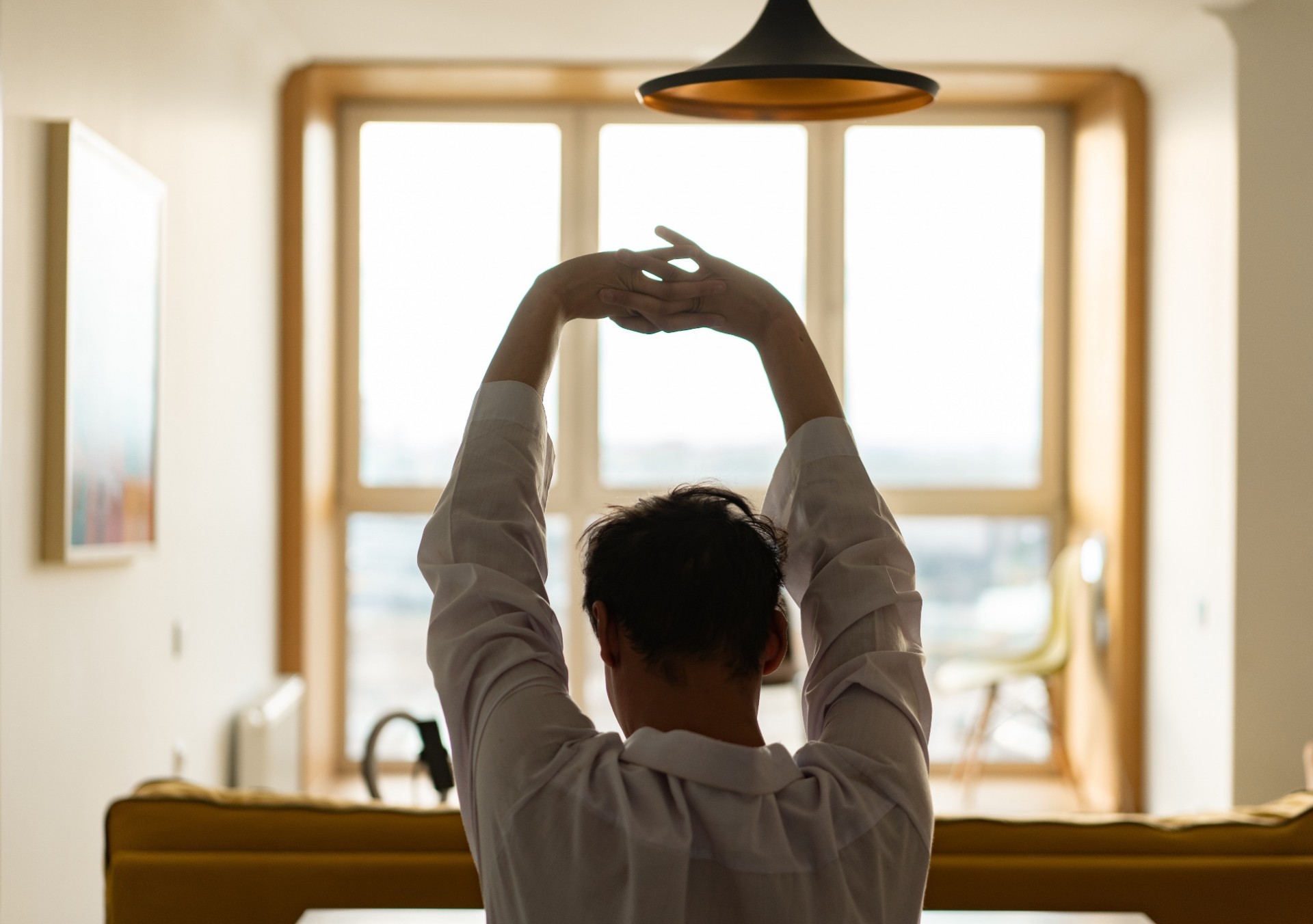 Person stretching both arms up