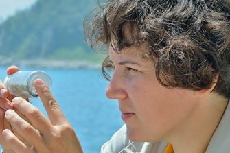 Woman scientist with ocean background