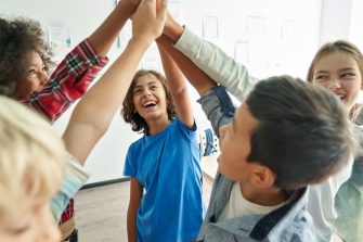 group of kids high five each other