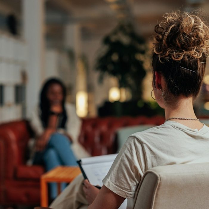 Woman counsellor talks to client in therapy session