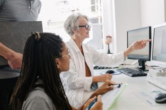 Two researchers looking at a computer screen