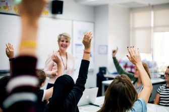 Hands go up for smiling teacher