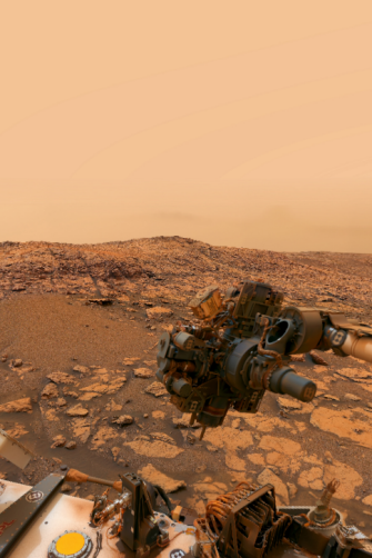 A red, rocky landscape of the planet Mars with scientific instruments in the immediate foregriund