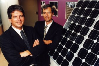 Martin Green and Stuart Wenham standing next to a panel of solar cells