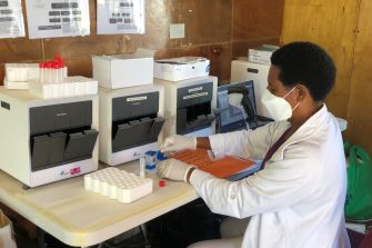 A woman holding a sample in a medical clinic.