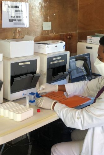 A woman holding a sample in a medical clinic.