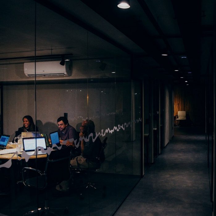 People in a meeting room with laptops